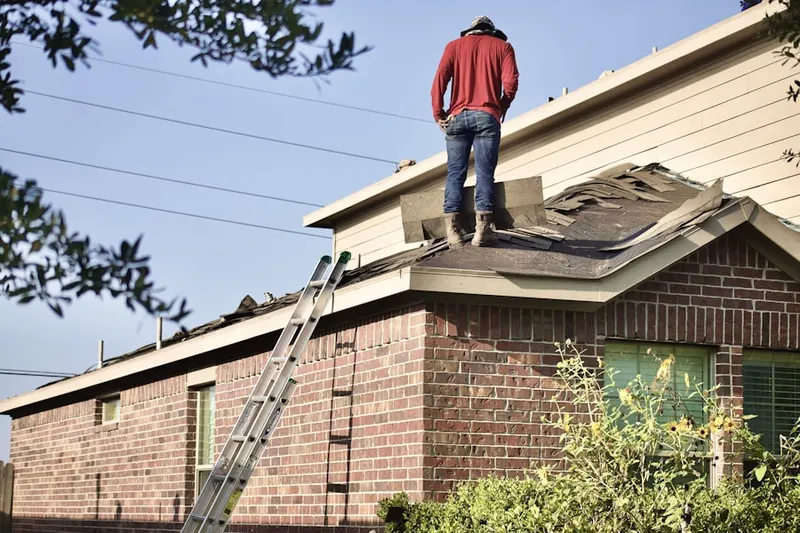 Professional roofer working on a residential roof in Central East Austin